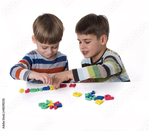 Photo: boys playing with rubber lettters boys playing with rubber lettters