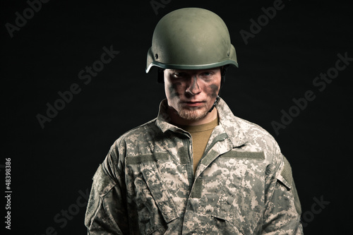 Photo: Military young man wearing helmet. Studio portrait. Military young man wearing helmet. Studio portrait.