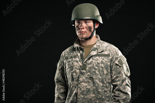 Photo: Military young man wearing helmet. Studio portrait. Military young man wearing helmet. Studio portrait.