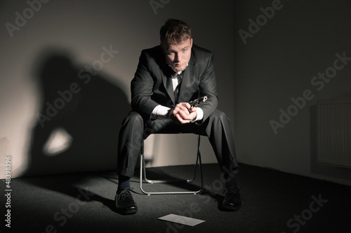 Photo: Suicidal business man in empty office. Suicidal business man in empty office.