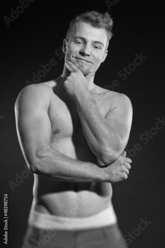Photo: Muscled fitness man. Black and white studio shot. Muscled fitness man. Black and white studio shot.