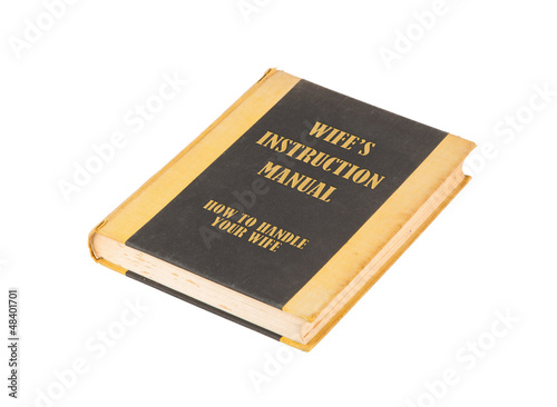 Photo: Old book with a wifes instructional manual concept title Old book with a wifes instructional manual concept title