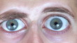Man's eyes growing to unreal size due to surprise and shock