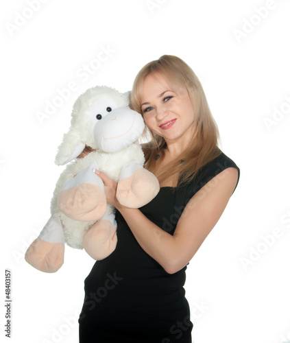Photo: Happy woman with toy sheep over white Happy woman with toy sheep over white