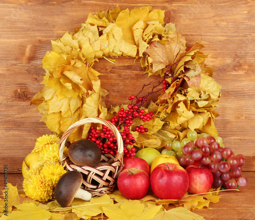 Photo: Autumnal composition with yellow leaves, apples and mushrooms Autumnal composition with yellow leaves, apples and mushrooms