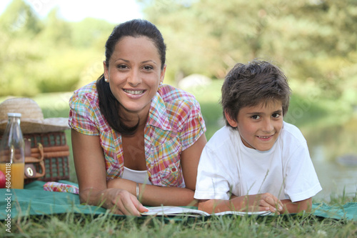 Photo: Mother and son enjoying a picnic Mother and son enjoying a picnic