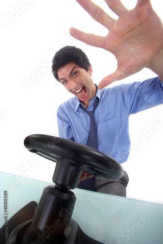 Photo: Excited businessman with video game steering wheel Excited businessman with video game steering wheel