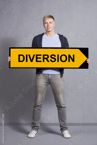 Photo: Man showing diversion sign. Man showing diversion sign.