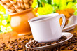 Photo: Coffee cup with fresh coffe beans for breakfast Coffee cup with fresh coffe beans for breakfast