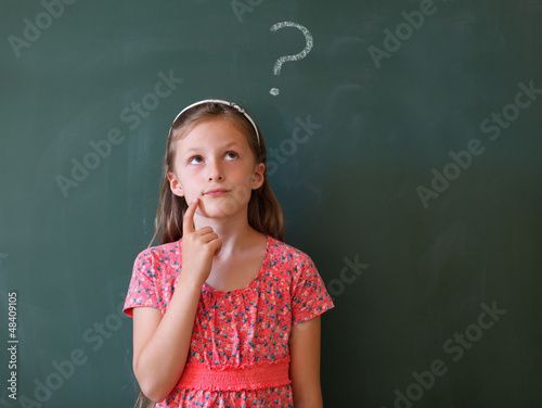 Photo: schoolgirl and blackboard with copy space schoolgirl and blackboard with copy space