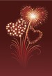 Firework in a shape of heart on the red background.