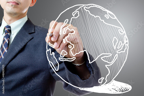 Photo: Businessman drawing Global Businessman drawing Global