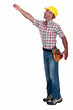 Construction worker reaching for something