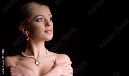 Photo: young woman with makeup in luxury jewelry young woman with makeup in luxury jewelry