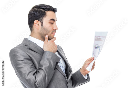 Photo: Businessman reading - looking papers, isolated Businessman reading - looking papers, isolated