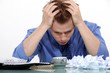 Desperate employee sitting at his desk