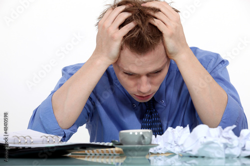 Photo: Desperate employee sitting at his desk Desperate employee sitting at his desk