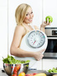 Photo: Smiling girl in the kitchen is proud of her healthy diet Smiling girl in the kitchen is proud of her healthy diet