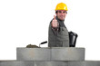 Mason giving the thumbs-up as her builds wall