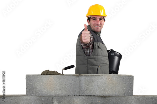 Photo: Mason giving the thumbs-up as her builds wall Mason giving the thumbs-up as her builds wall