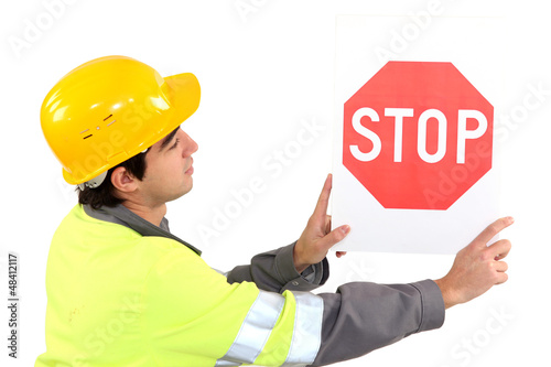 Photo: Laborer showing stop sign Laborer showing stop sign