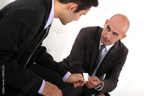 Photo: Businessmen exchanging cards Businessmen exchanging cards