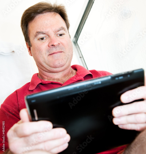 Photo: Man in Bathroom with Tablet PC Man in Bathroom with Tablet PC