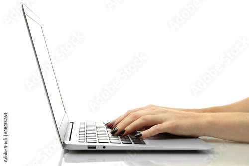 Photo: female hands writing on laptot, isolated on white female hands writing on laptot, isolated on white