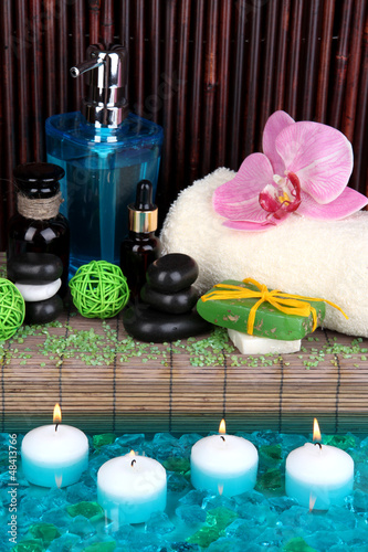 Photo: Beautiful spa setting near pool on bamboo background Beautiful spa setting near pool on bamboo background