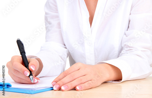 Photo: Closeup of businesswoman hands, writing on paper Closeup of businesswoman hands, writing on paper