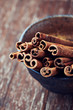 Close up of cinnamon sticks in a ceramic dish