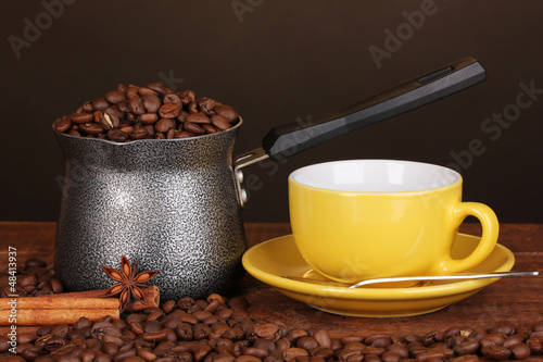 Photo: Coffee maker with yellow cup on wooden table Coffee maker with yellow cup on wooden table