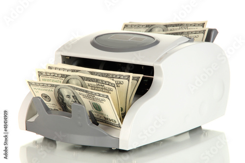 Photo: Machine for counting money and 100 dollar bills isolated Machine for counting money and 100 dollar bills isolated