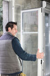 Foto: Worker installing French doors Worker installing French doors