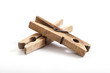 Foto: old wooden clothes pegs on white background old wooden clothes pegs on white background