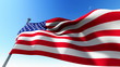 flag of USA waving in the wind against blue sky