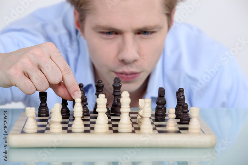 Photo: Man playing chess Man playing chess
