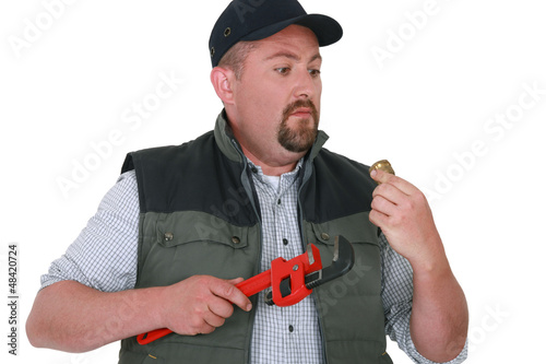 Photo: Apprehensive handyman staring at an object Apprehensive handyman staring at an object
