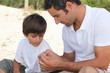 Father teaching son how to fish