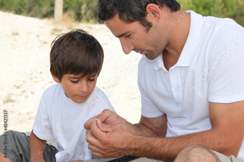 Photo: Father teaching son how to fish Father teaching son how to fish