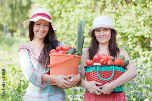 Photo: happy women with vegetables harvest happy women with vegetables harvest