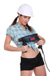 Sexy woman holding an electric screwdriver