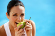 Woman eating a pear
