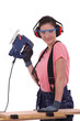 Woman using an electric saw