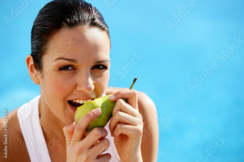 Photo: Woman eating a pear Woman eating a pear