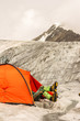 The climber has a rest lying in tent on glacier