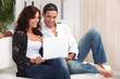 Couple on a sofa with a laptop