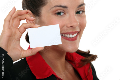 Photo: Woman presenting business card Woman presenting business card