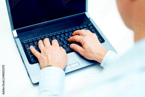 Photo: Image of businessman working on laptop Image of businessman working on laptop