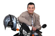 Smiling man sitting on a motorbike